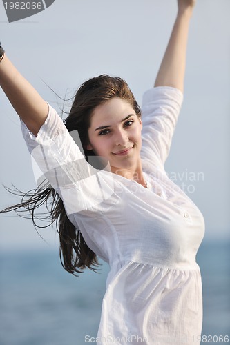 Image of young woman enjoy on beach