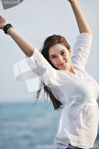 Image of young woman enjoy on beach