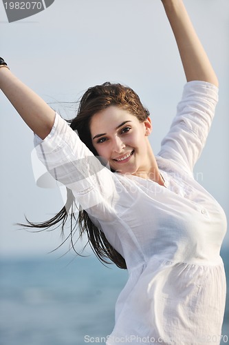 Image of young woman enjoy on beach