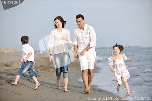 Image of happy young family have fun on beach