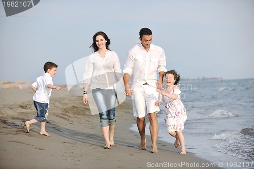 Image of happy young family have fun on beach