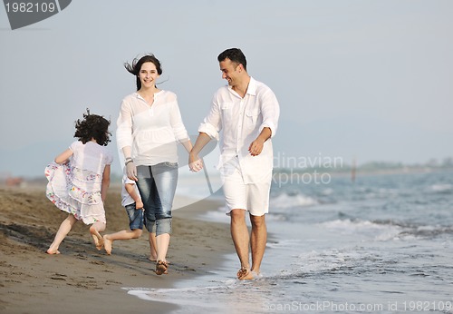 Image of happy young family have fun on beach