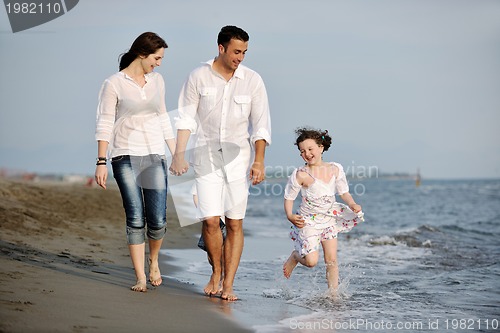 Image of happy young family have fun on beach