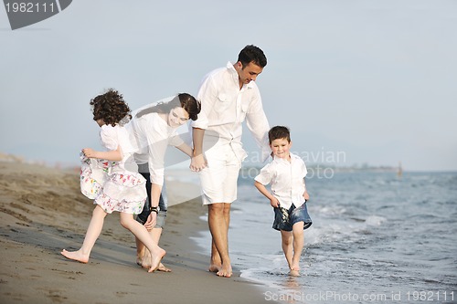 Image of happy young family have fun on beach