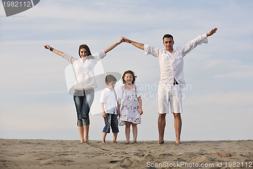 Image of family on beach showing home sign