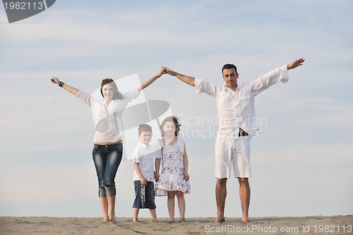 Image of family on beach showing home sign