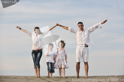 Image of family on beach showing home sign