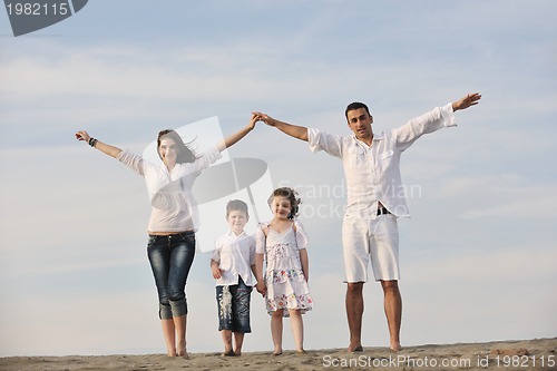 Image of family on beach showing home sign