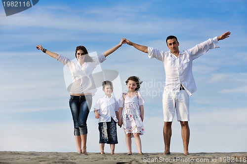 Image of family on beach showing home sign