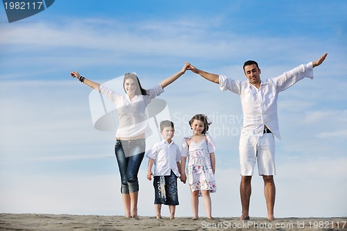 Image of family on beach showing home sign