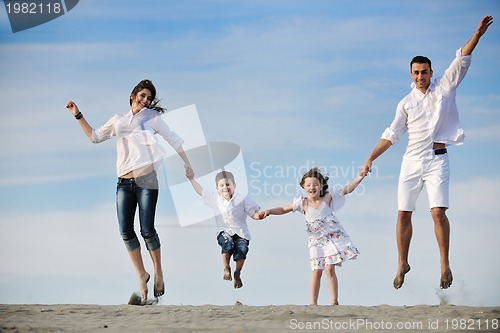 Image of family on beach showing home sign