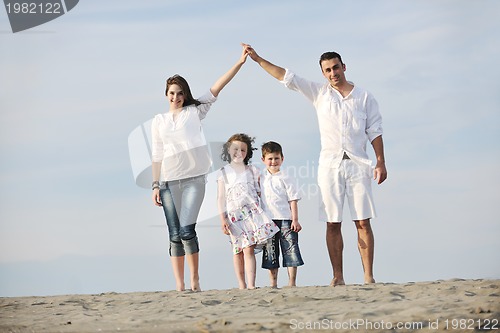 Image of family on beach showing home sign