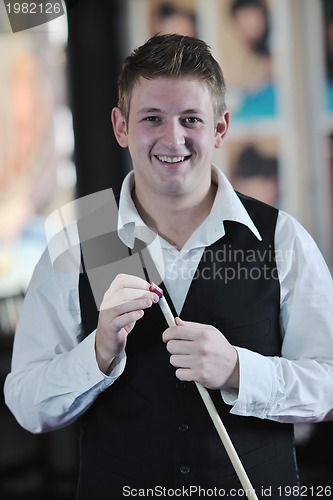 Image of young man play pro billiard game 