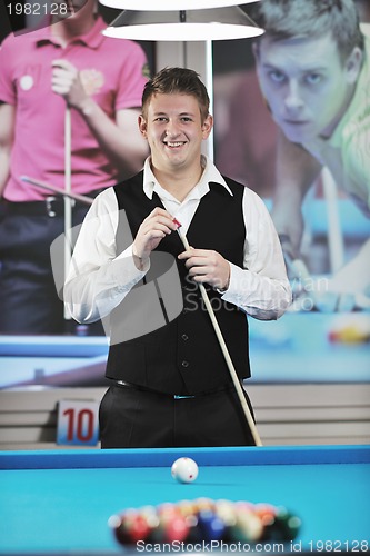 Image of young man play pro billiard game 