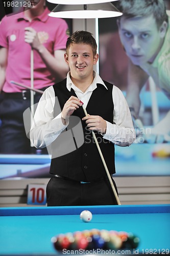 Image of young man play pro billiard game 