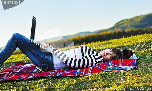 Image of young teen girl work on laptop outdoor