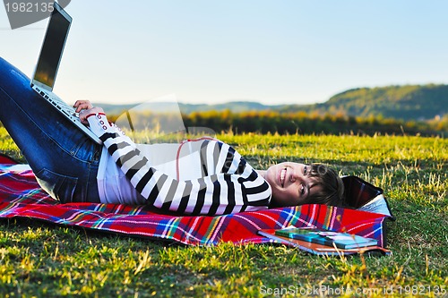 Image of young teen girl work on laptop outdoor