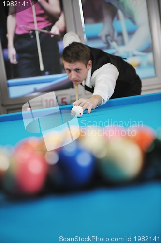 Image of young man play pro billiard game 