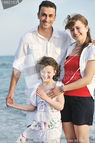 Image of happy young family have fun on beach