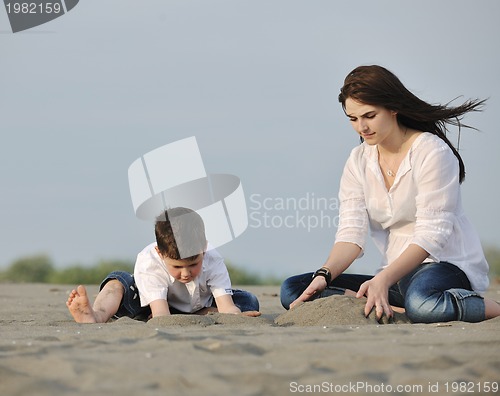 Image of mom and son relaxing on beach