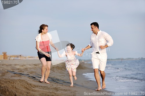 Image of happy young family have fun on beach
