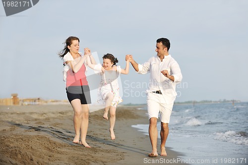 Image of happy young family have fun on beach