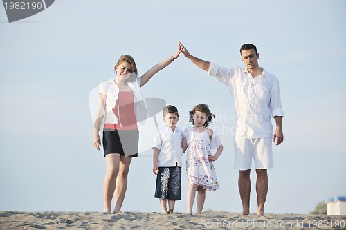 Image of family on beach showing home sign