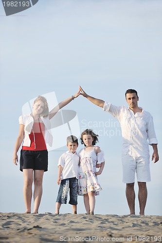 Image of family on beach showing home sign