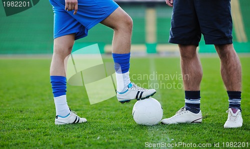 Image of football players in competition for the ball