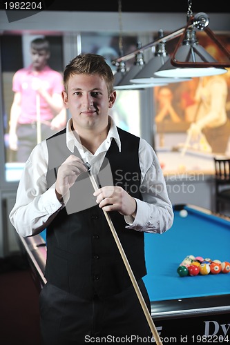 Image of young man play pro billiard game 