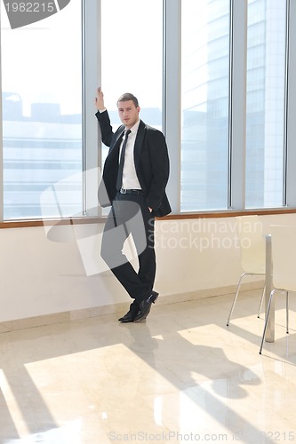Image of young business man alone in conference room