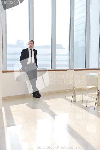 Image of young business man alone in conference room