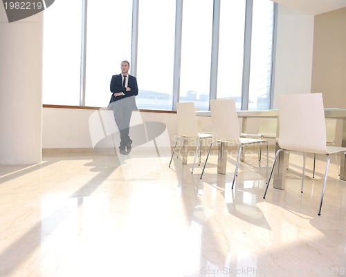 Image of young business man alone in conference room