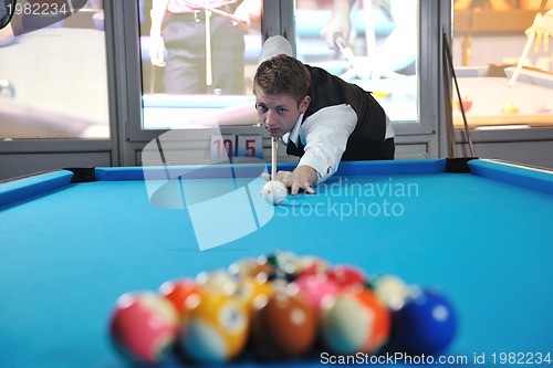 Image of young man play pro billiard game 