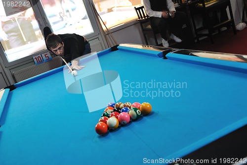 Image of young man play pro billiard game 