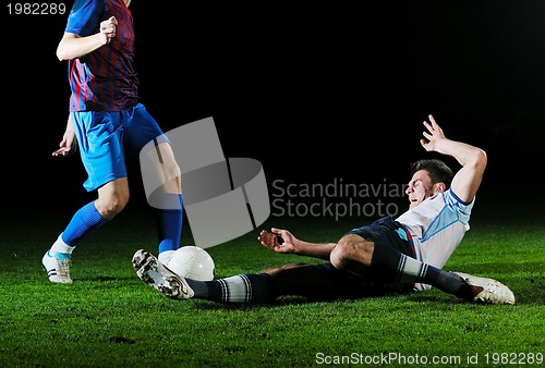 Image of football players in competition for the ball