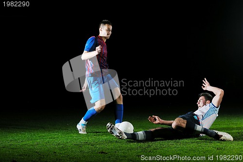 Image of football players in competition for the ball