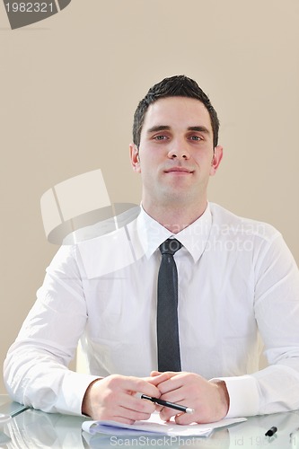 Image of  business man alone in conference room
