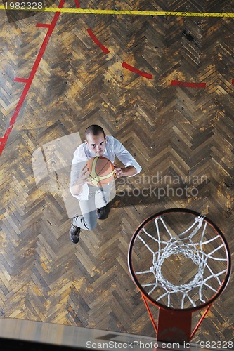 Image of businessman holding basketball ball