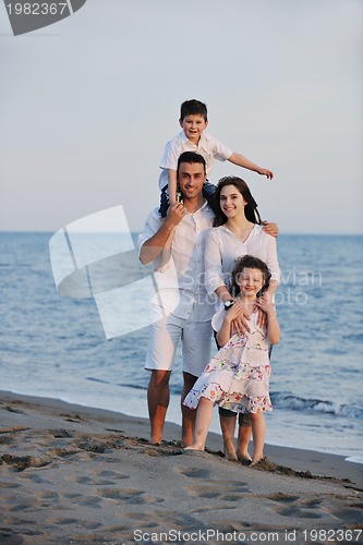 Image of happy young family have fun on beach