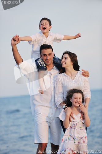 Image of happy young family have fun on beach