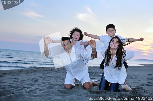 Image of happy young family have fun on beach