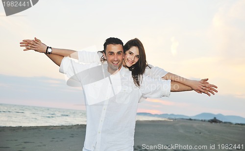 Image of happy young couple have fun on beach