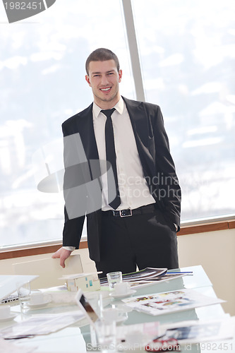 Image of young business man alone in conference room