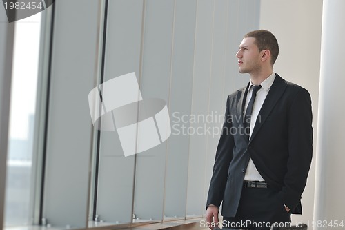 Image of young business man alone in conference room