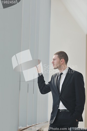 Image of young business man alone in conference room