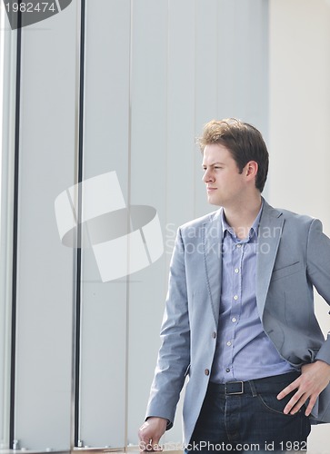 Image of young business man alone in conference room