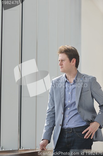 Image of young business man alone in conference room