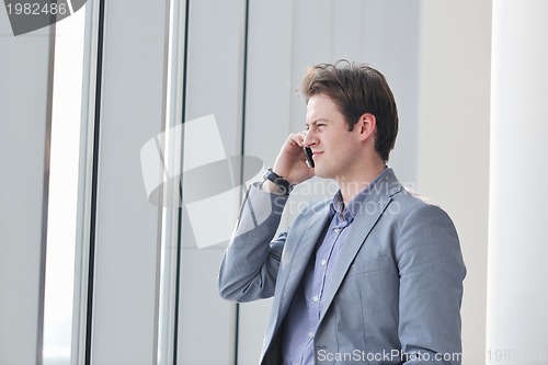 Image of young business man talk by cellphone