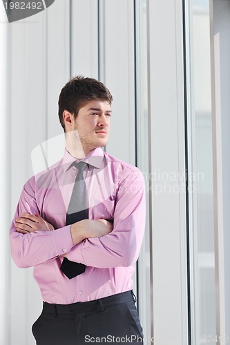 Image of young business man alone in conference room